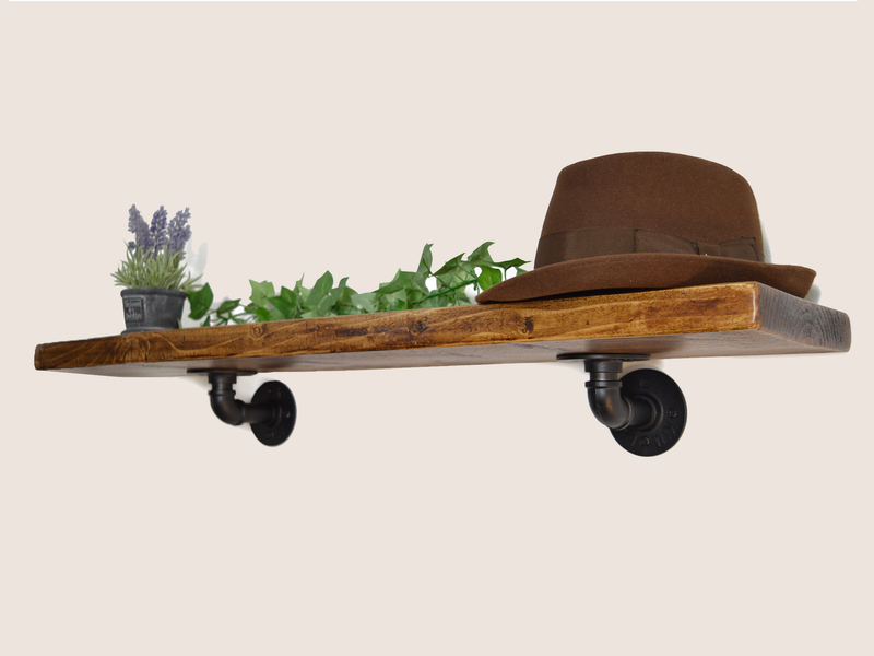 industrial style wooden shelf with pipe brackets.