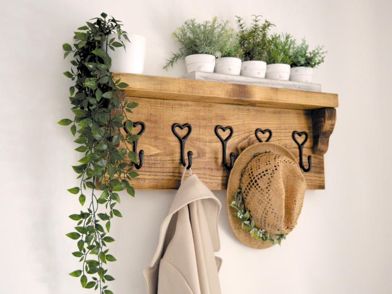 wooden, wall mounted coat rack with shelf.